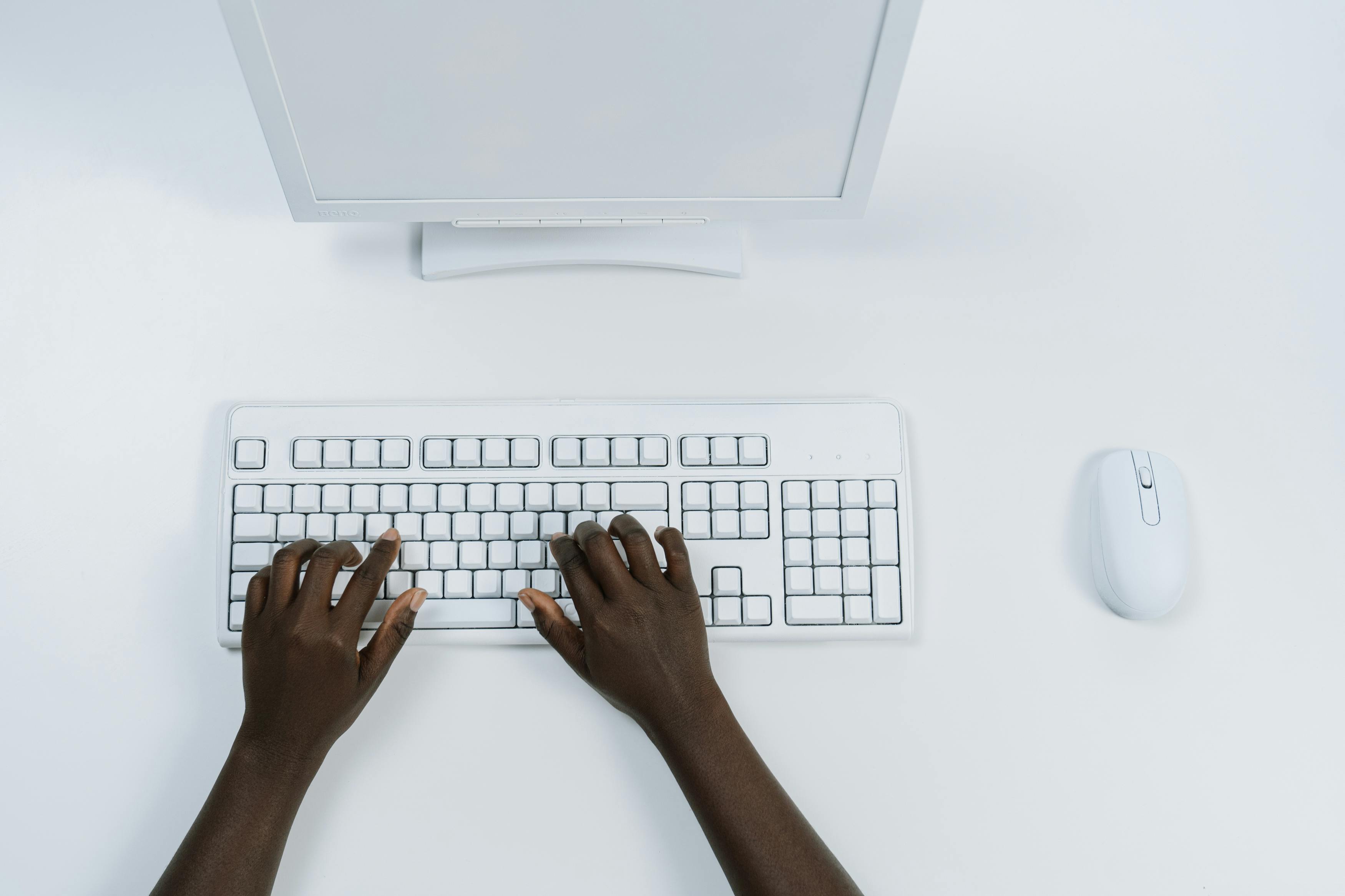 Hands typing on keyboard — technology workspace